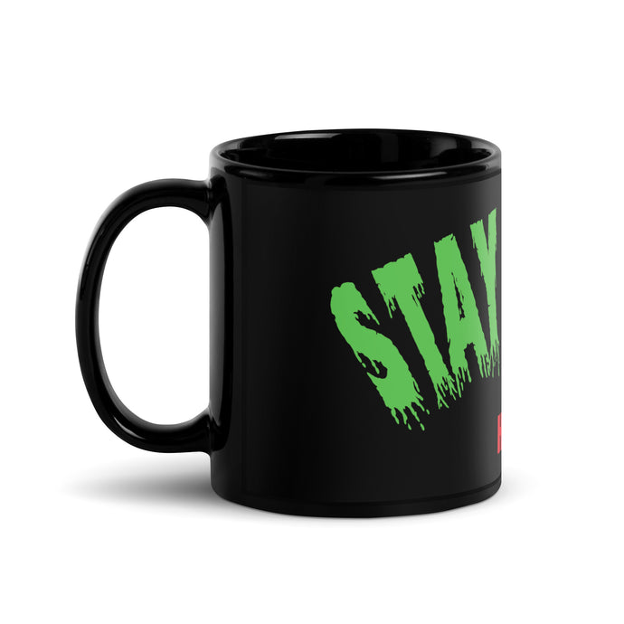 Black mug with ‘Stay Weird’ print.