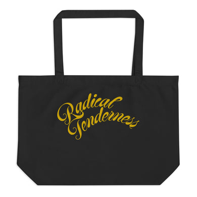 Front view of black tote with Radical Tenderness embroidered in gold cursive letters.