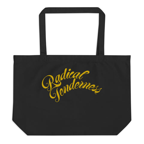 Front view of black tote with Radical Tenderness embroidered in gold cursive letters.